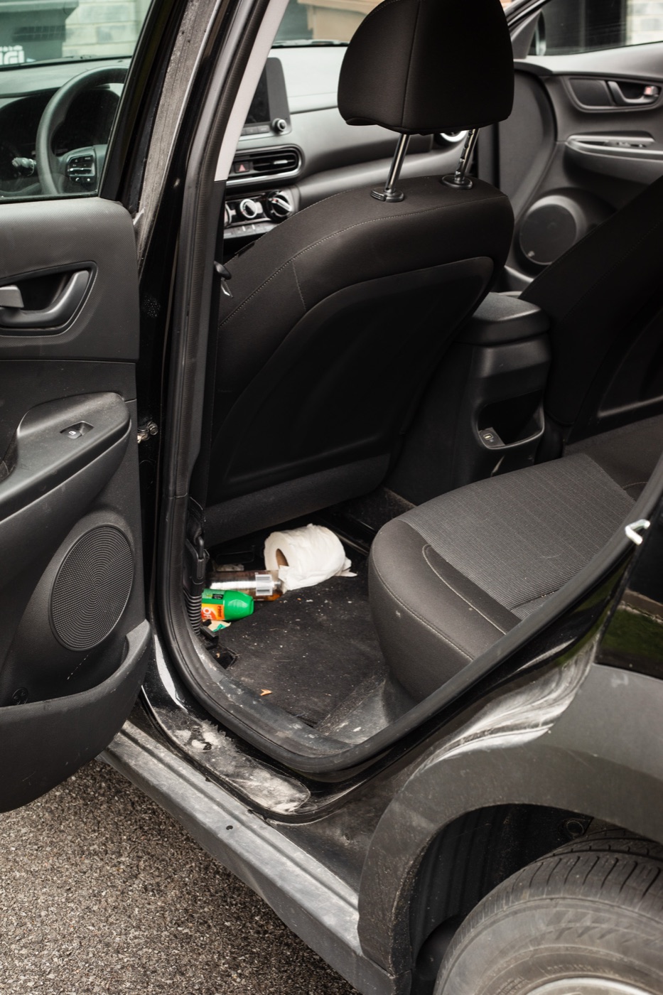Hyundai Kona rear interior covered in trash and debris before detail
