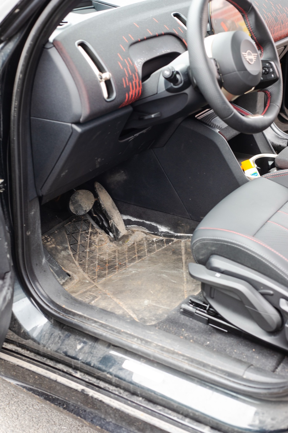 Mini Cooper driver footwell heavily soiled before detail